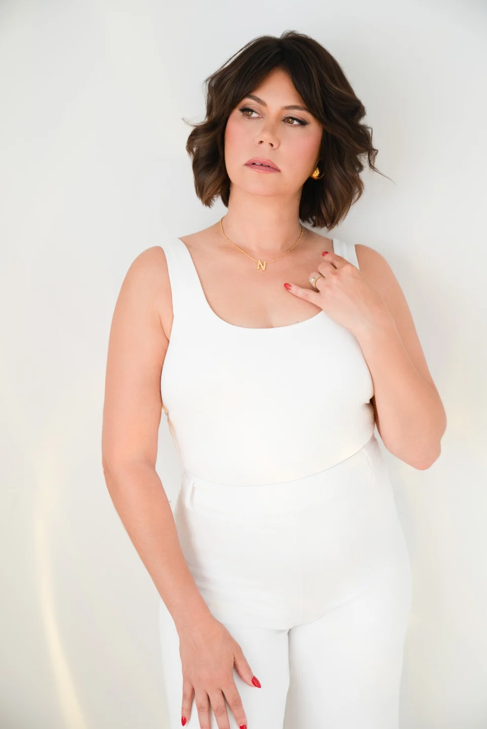 Portrait in white against a light studio backdrop